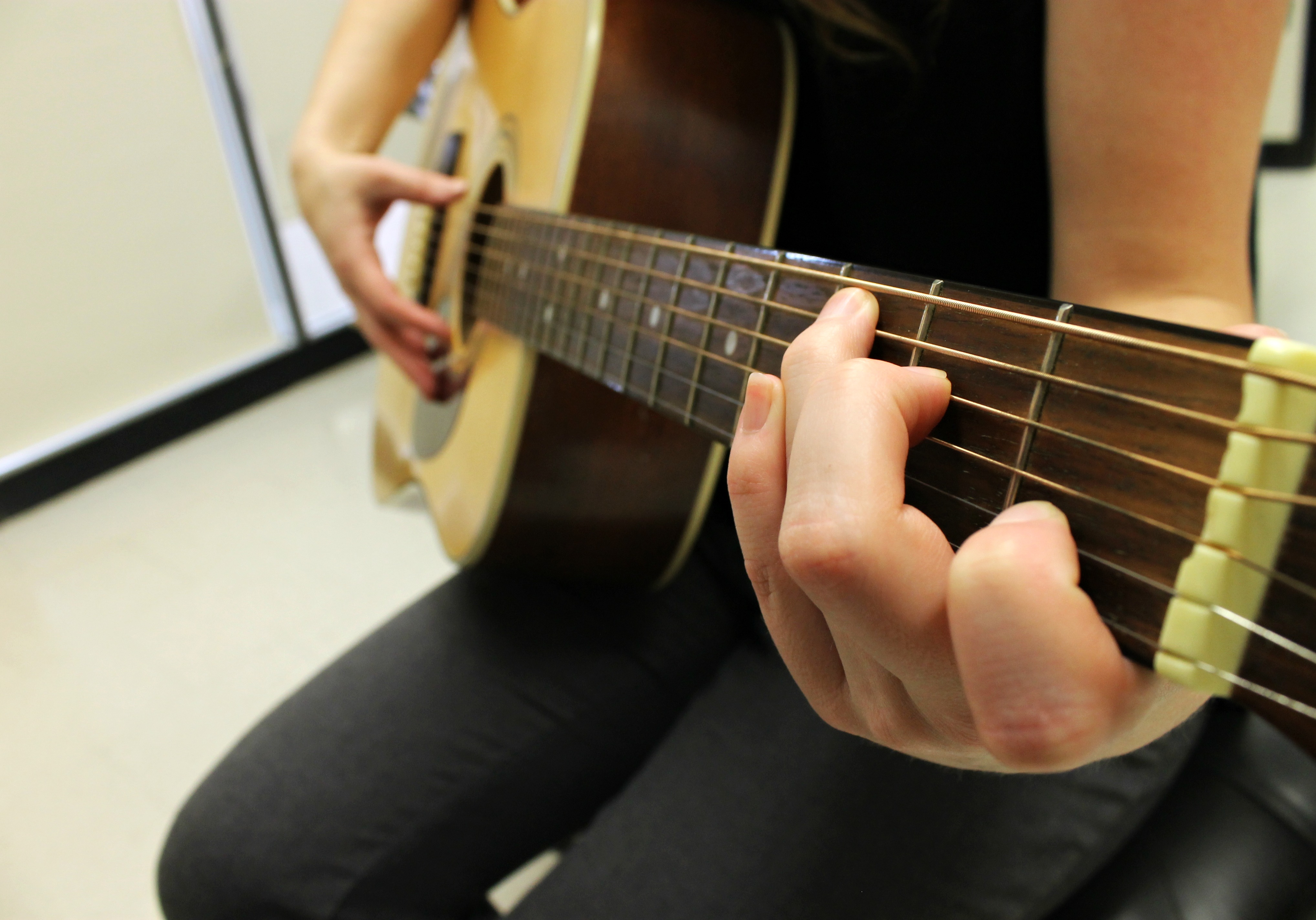 hand on guitar frets